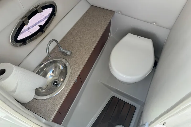 Slide: The Image of 2013 Crownline Eclipse E6 XS boat bathroom with sink and toilet. - 15