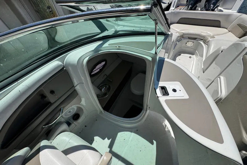 Slide: The Image of 2013 Crownline Eclipse E6 XS boat interior with seating and storage compartments. - 16