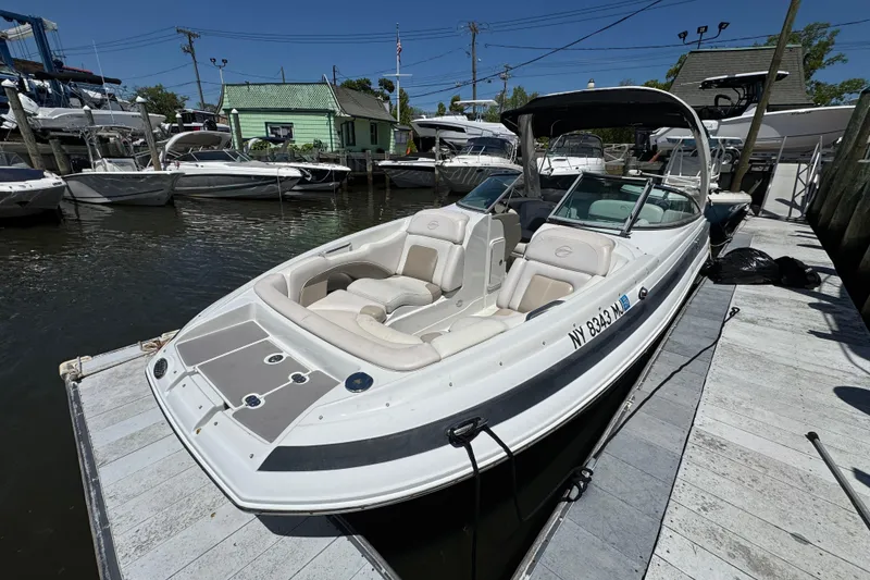 Slide: The Image of 2013 Crownline Eclipse E6 XS boat docked at marina, featuring spacious seating and sleek design. - 22