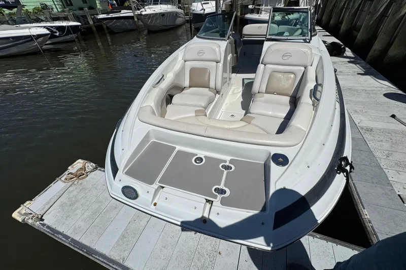 Slide: The Image of 2013 Crownline Eclipse E6 XS boat docked, featuring spacious seating and sleek design. - 23