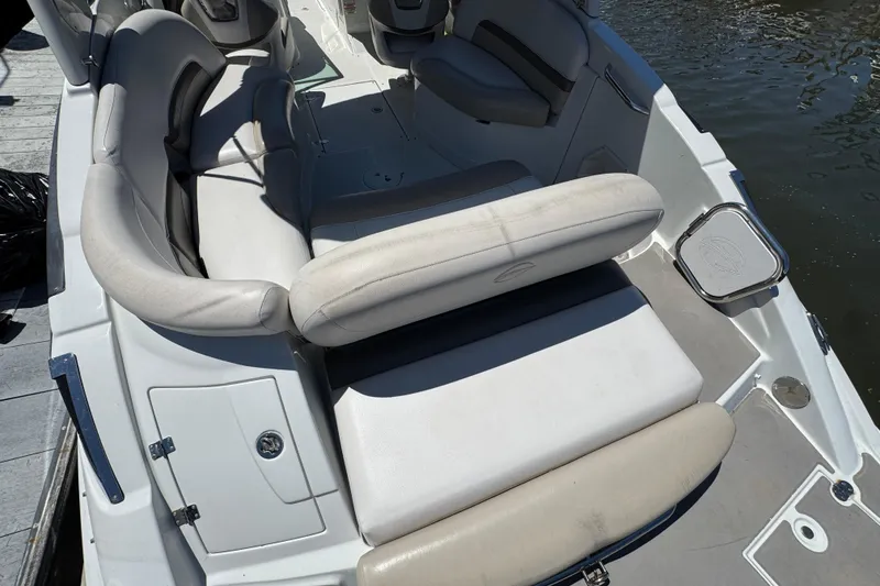 Slide: The Image of 2013 Crownline Eclipse E6 XS boat interior with white seating and water view. - 6