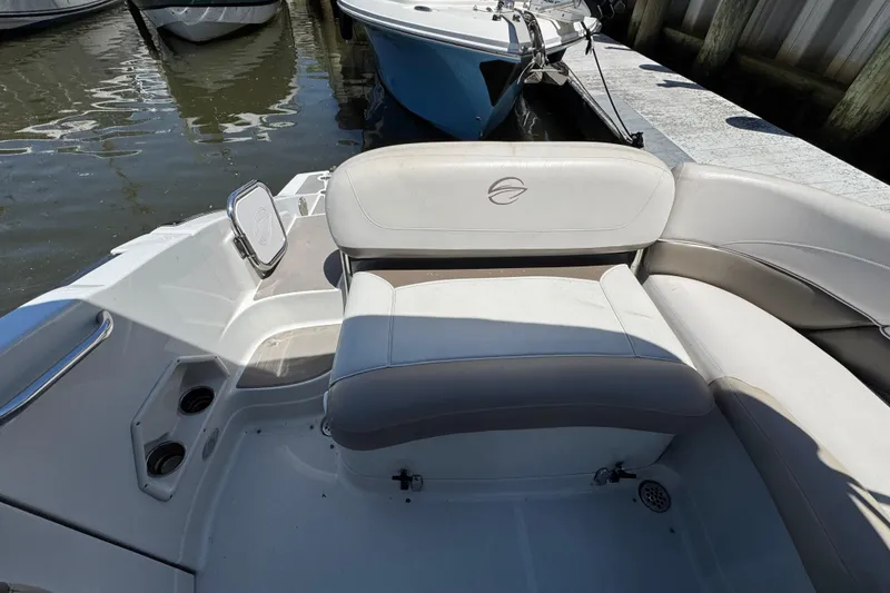 Slide: The Image of 2013 Crownline Eclipse E6 XS boat interior with cushioned seating and cup holders. - 8