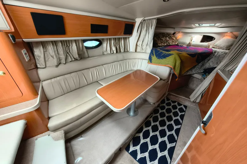 Slide: The Image of Interior of a 2001 Regal Commodore 3260 yacht with cozy seating area. - 16