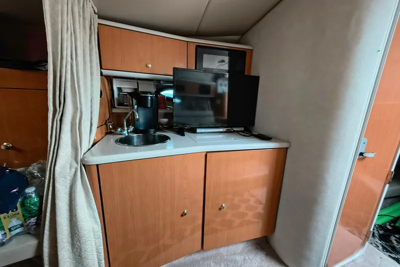 Slide: The Image of Interior of Regal Commodore 3260 yacht with kitchenette, TV, and sink. - 17