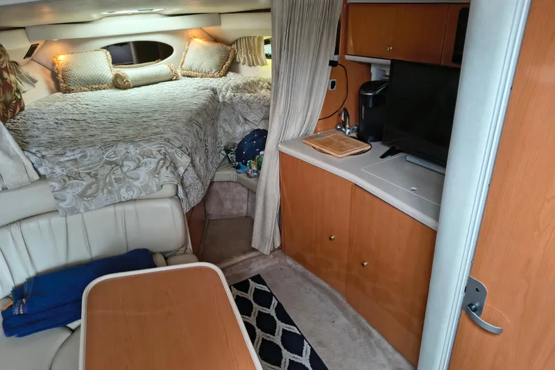 Slide: The Image of Interior of a 2001 Regal Commodore 3260 yacht with bed and kitchenette. - 19