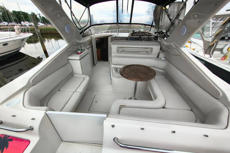 Slide: The Image of Spacious interior of 2001 Regal Commodore 3260 yacht with plush seating and wooden table. - 7