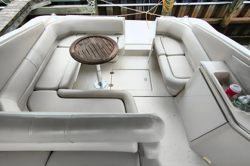 Slide: The Image of 2001 Regal Commodore 3260 boat interior with beige seating and wooden table. - 8