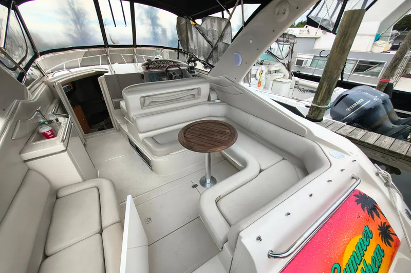 Slide: The Image of 2001 Regal Commodore 3260 boat interior with seating, table, and helm station. - 9
