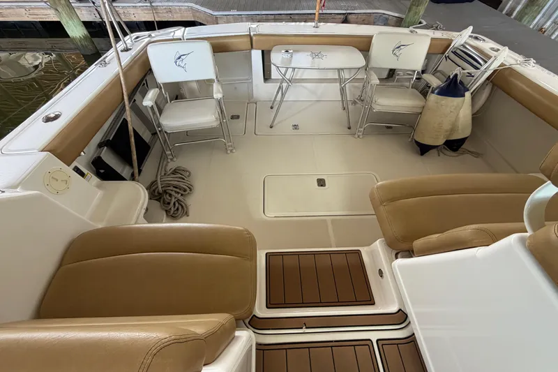 Slide: The Image of 2002 Tiara Yachts 3800 Open cockpit with seating, table, and nautical decor. - 10