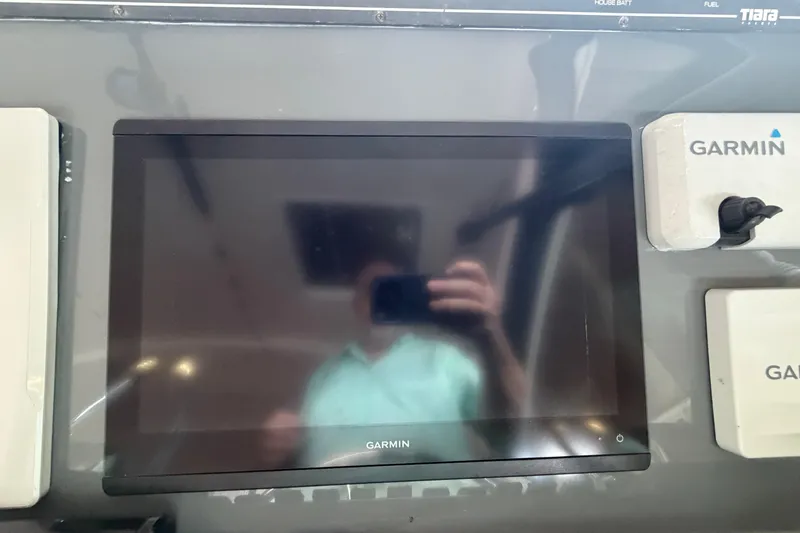 Slide: The Image of Garmin display on 2002 Tiara Yachts 3800 Open dashboard, reflecting a person taking a photo. - 11
