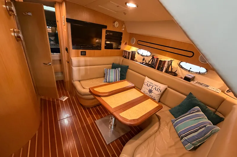 Slide: The Image of Luxurious interior of a 2002 Tiara Yachts 3800 Open with cozy seating and nautical decor. - 15