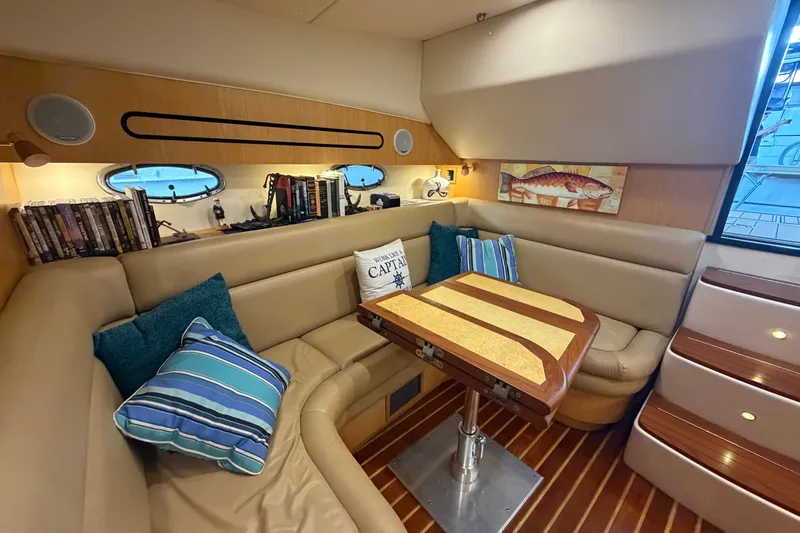 Slide: The Image of Luxurious interior of 2002 Tiara Yachts 3800 Open with cozy seating and nautical decor. - 16