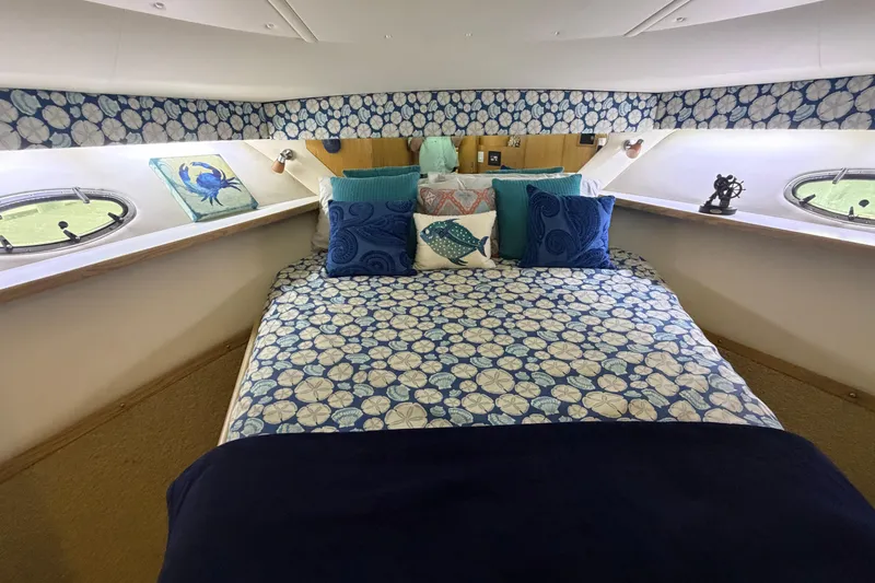 Slide: The Image of Luxurious cabin interior of 2002 Tiara Yachts 3800 Open with nautical-themed bedding. - 23