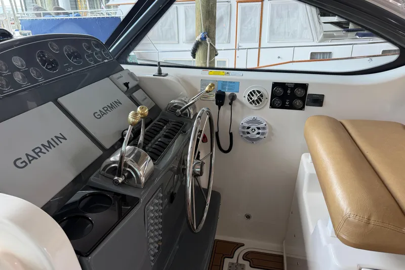 Slide: The Image of Helm of 2002 Tiara Yachts 3800 Open with Garmin navigation systems and controls. - 27