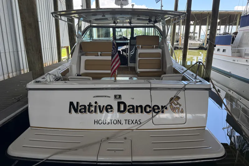 Slide: The Image of 2002 Tiara Yachts 3800 Open docked, named "Native Dancer," in Houston, Texas marina. - 3