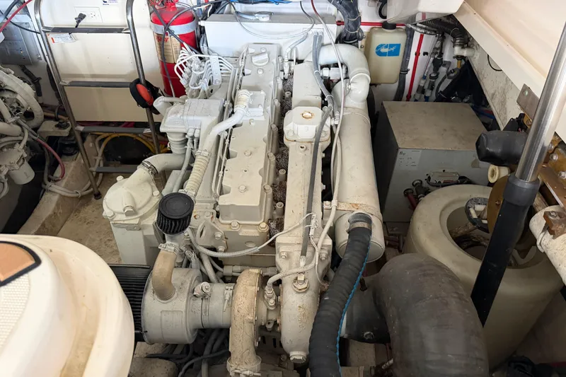 Slide: The Image of Engine room of a 2002 Tiara Yachts 3800 Open, showcasing mechanical components and fire extinguisher. - 30