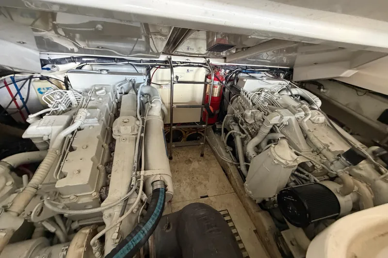 Slide: The Image of Engine room of a 2002 Tiara Yachts 3800 Open, showcasing dual engines and mechanical components. - 32