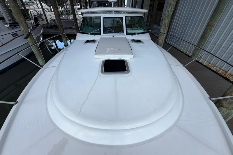 Slide: The Image of 2002 Tiara Yachts 3800 Open boat deck in a marina setting. - 34