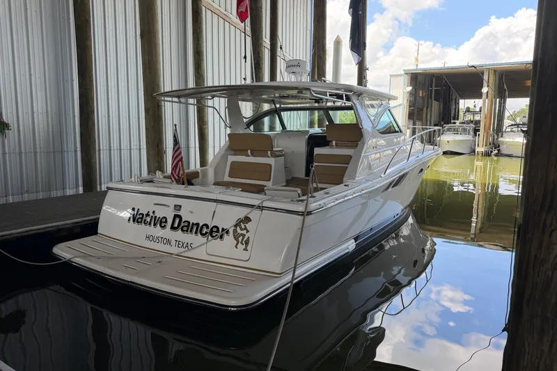 Slide: The Image of 2002 Tiara Yachts 3800 Open docked, named "Native Dancer," in Houston, Texas marina. - 5