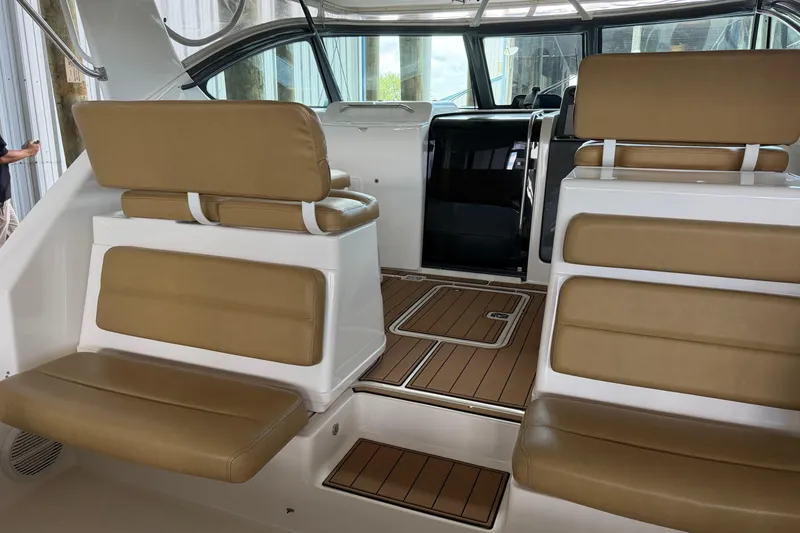 Slide: The Image of 2002 Tiara Yachts 3800 Open interior with tan leather seating and wood flooring. - 7