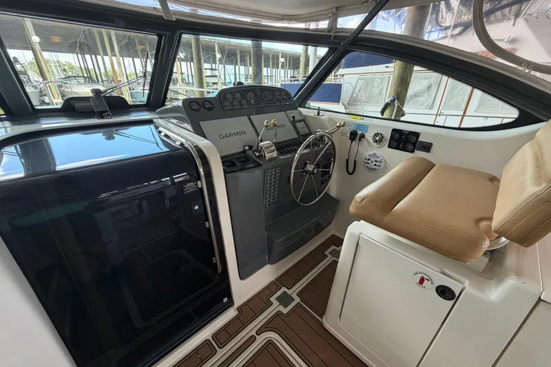 Slide: The Image of Helm of 2002 Tiara Yachts 3800 Open with Garmin navigation and leather seating. - 8