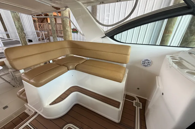 Slide: The Image of Luxurious seating area on a 2002 Tiara Yachts 3800 Open, featuring tan cushions and sleek design. - 9