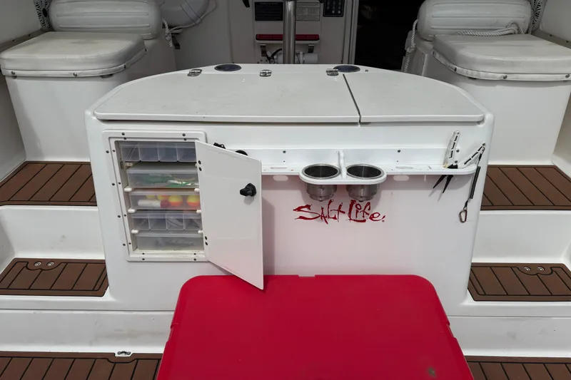 Slide: The Image of 2001 Pursuit 3000 Offshore boat interior with fishing gear storage and "Salt Life" decal. - 11
