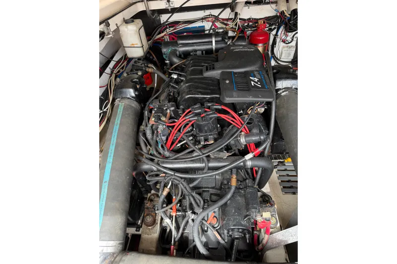 Slide: The Image of Engine compartment of a 2001 Pursuit 3000 Offshore boat, showcasing wiring and components. - 14