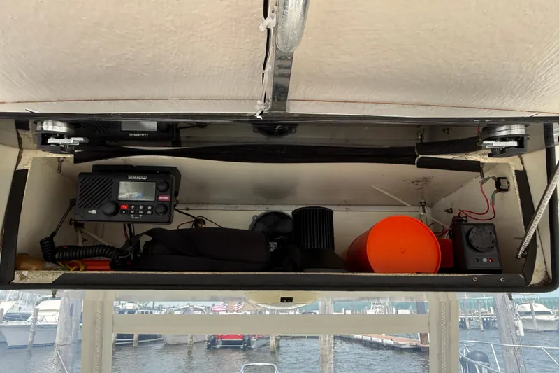 Slide: The Image of 2001 Pursuit 3000 Offshore boat electronics compartment with Simrad radio and marine equipment. - 15