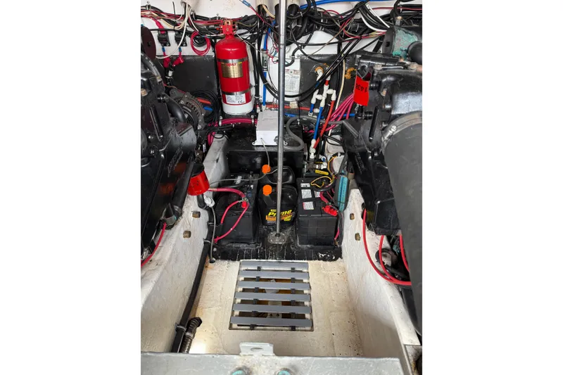 Slide: The Image of Engine compartment of a 2001 Pursuit 3000 Offshore boat, featuring wiring and fire extinguisher. - 17