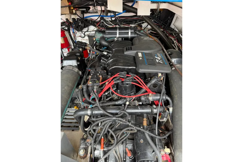 Slide: The Image of Engine compartment of a 2001 Pursuit 3000 Offshore boat, showcasing detailed wiring and components. - 21