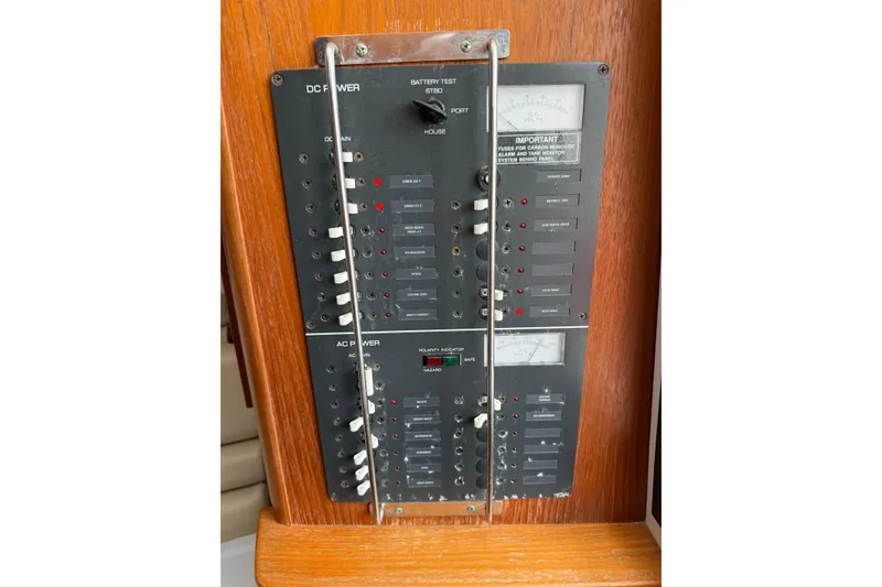 Slide: The Image of Electrical panel on a 2001 Pursuit 3000 Offshore boat, featuring DC and AC power controls. - 23