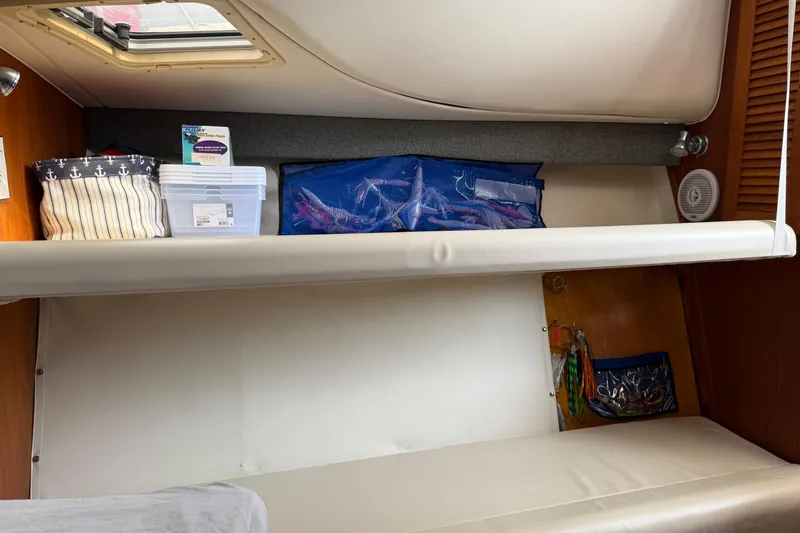 Slide: The Image of Interior cabin storage on a 2001 Pursuit 3000 Offshore boat with organized shelves. - 29