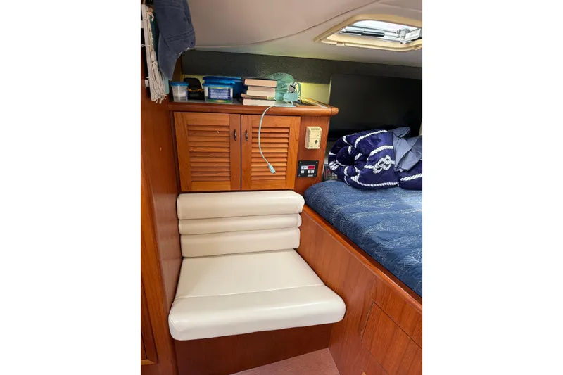 Slide: The Image of Interior of a 2001 Pursuit 3000 Offshore boat with seating and storage. - 32
