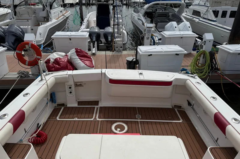 Slide: The Image of 2001 Pursuit 3000 Offshore boat docked, featuring spacious deck and modern amenities. - 6