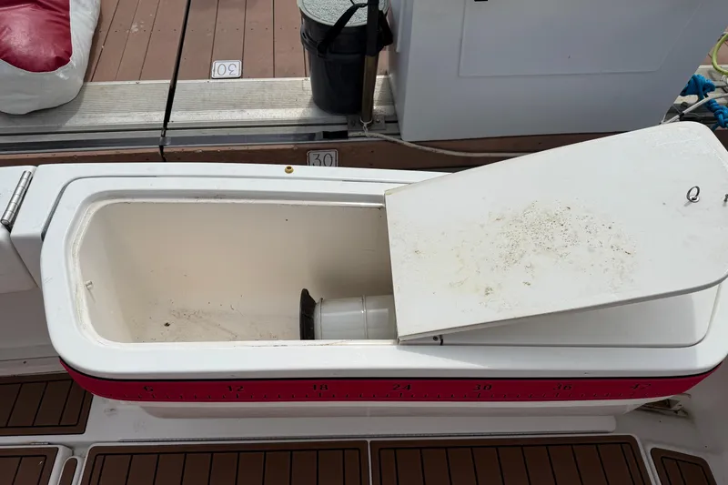 Slide: The Image of Open storage compartment on a 2001 Pursuit 3000 Offshore boat deck. - 9