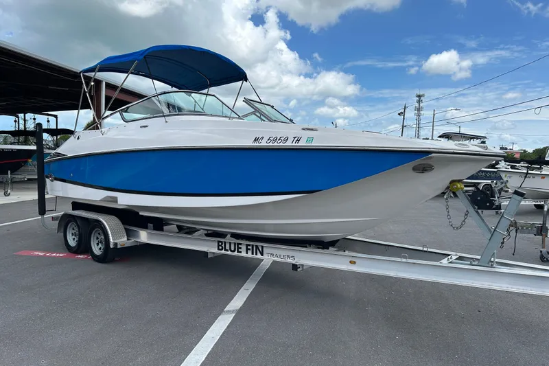 The Image of 2008 Regal 2520 FasDeck boat on Blue Fin trailer, parked outdoors under blue sky. - 1