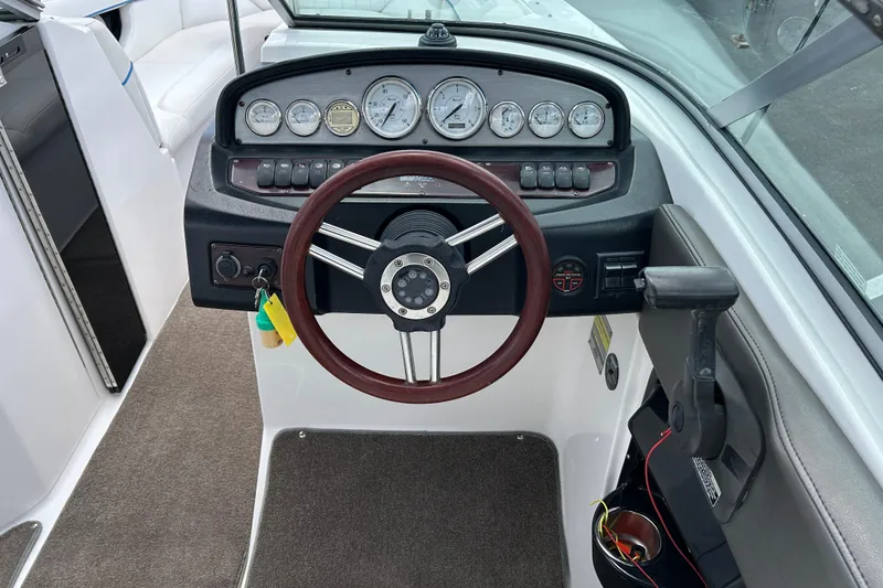 Slide: The Image of 2008 Regal 2520 FasDeck boat dashboard with steering wheel and instrument panel. - 10