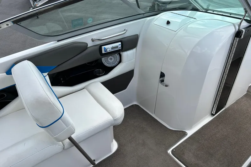 Slide: The Image of Interior of a 2008 Regal 2520 FasDeck boat, featuring white seating and modern controls. - 11