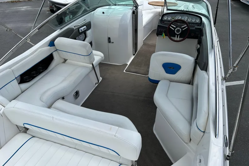 Slide: The Image of Interior of a 2008 Regal 2520 FasDeck boat with white seating and dashboard. - 14