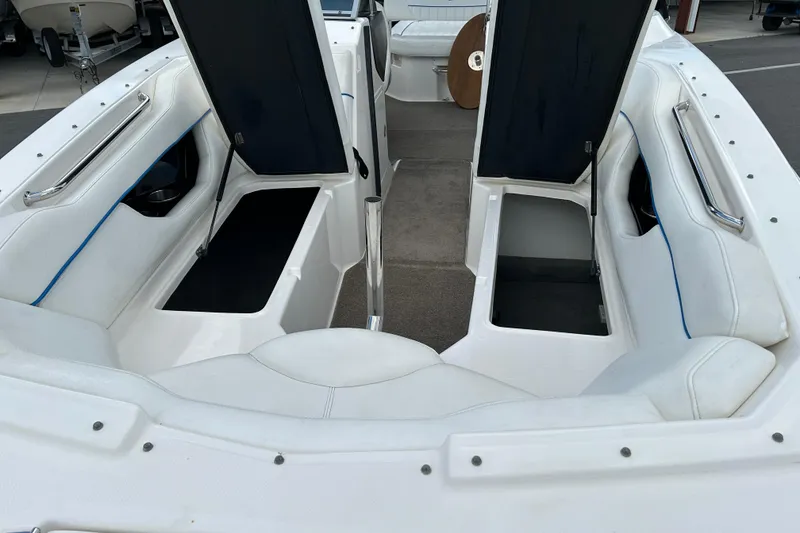 Slide: The Image of 2008 Regal 2520 FasDeck boat interior with open storage compartments and white seating. - 15