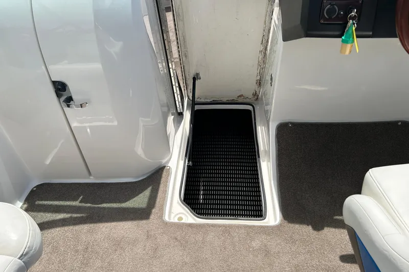 Slide: The Image of Interior view of a 2008 Regal 2520 FasDeck boat, featuring a storage compartment. - 17