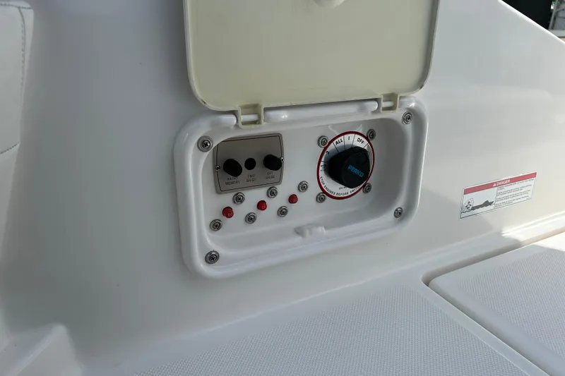 Slide: The Image of Control panel on a 2008 Regal 2520 FasDeck boat, featuring switches and dials. - 19