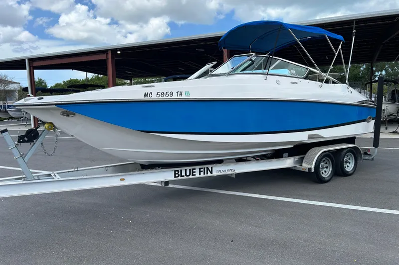 Slide: The Image of 2008 Regal 2520 FasDeck boat on trailer, blue and white design, parked outdoors. - 5