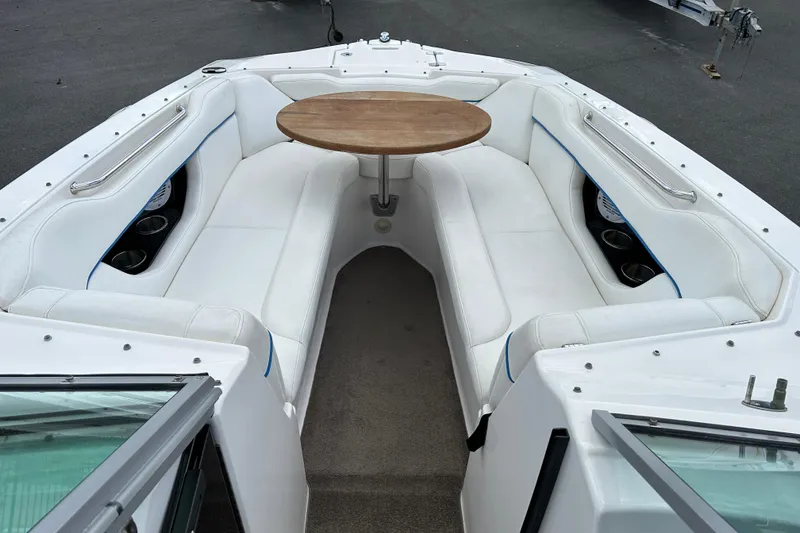 Slide: The Image of 2008 Regal 2520 FasDeck boat interior with white seating and wooden table. - 8
