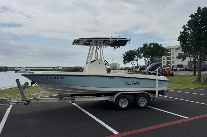 Slide: The Image of 2014 Boston Whaler 210 Dauntless boat on trailer, parked near waterfront. - 10