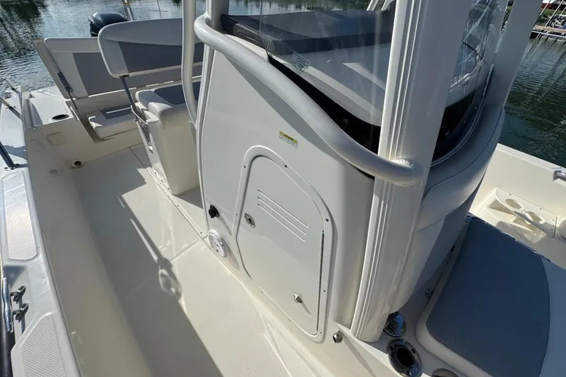 Slide: The Image of 2014 Boston Whaler 210 Dauntless boat interior with seating and storage compartments. - 17