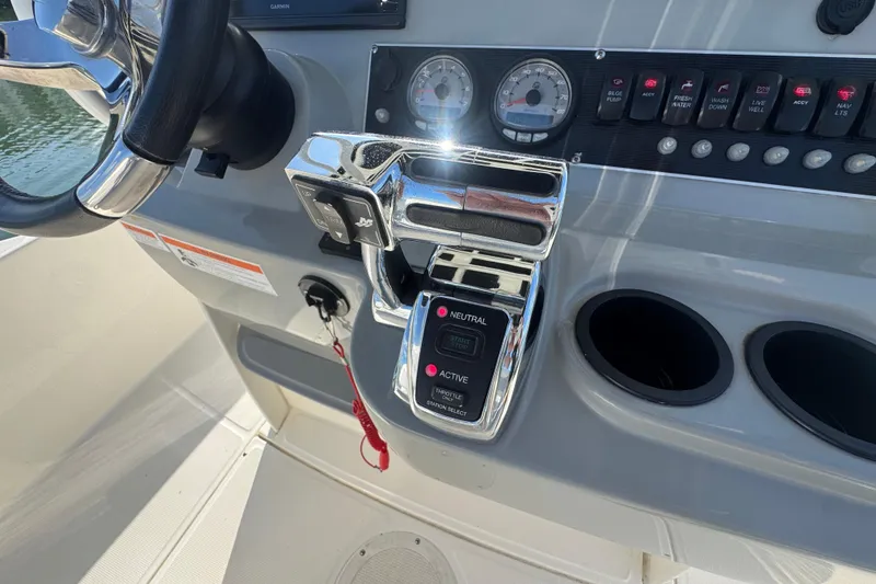 Slide: The Image of Control panel of a 2014 Boston Whaler 210 Dauntless boat with steering wheel and throttle. - 19