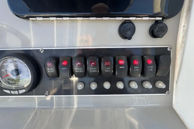 Slide: The Image of Control panel of a 2014 Boston Whaler 210 Dauntless with switches and speedometer. - 20