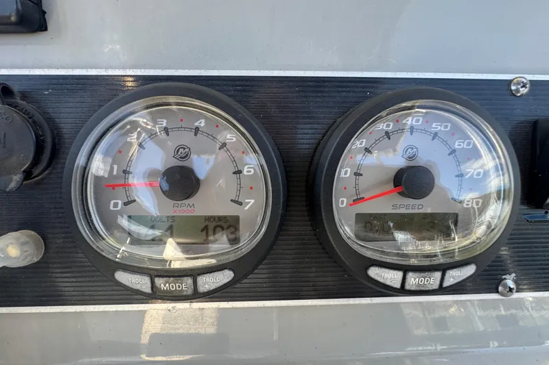 Slide: The Image of Dashboard gauges of a 2014 Boston Whaler 210 Dauntless boat, showing RPM and speed. - 21